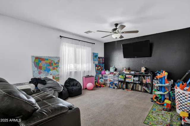 a living room with lots of furniture and a flat screen tv
