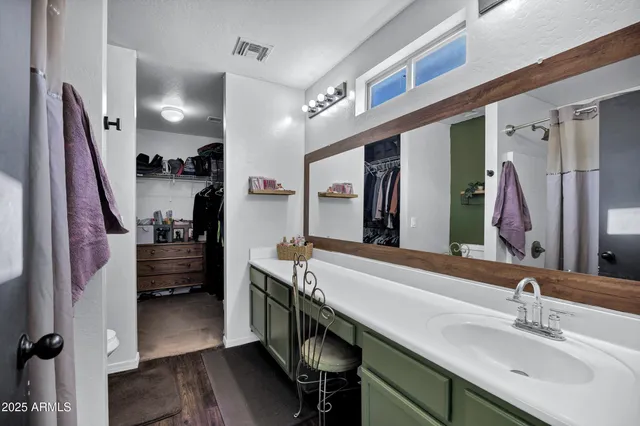 a bathroom with a sink a mirror and a bathtub