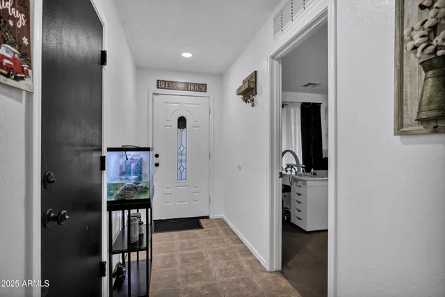 a view of hallway with furniture and a livingroom