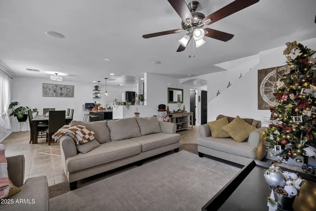 a living room with furniture and a chandelier