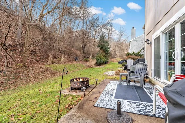 a view of a patio with table and chairs and potted plants