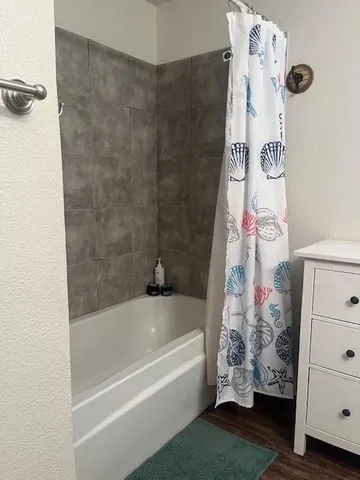 a bathroom with a bathtub and shower