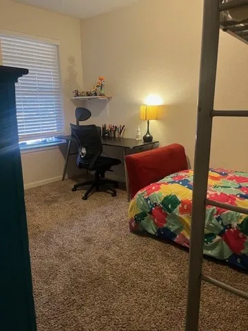 a bedroom with a bed and a window