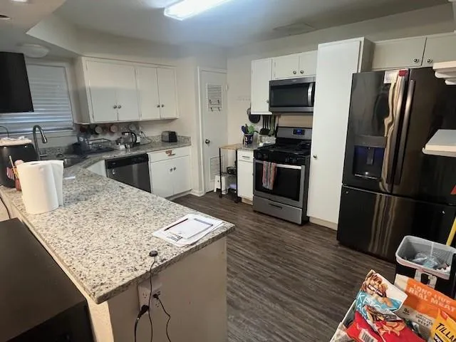 a kitchen with granite countertop stainless steel appliances and wooden cabinets