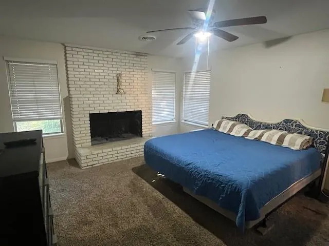 a bed sitting in a room next to a fireplace