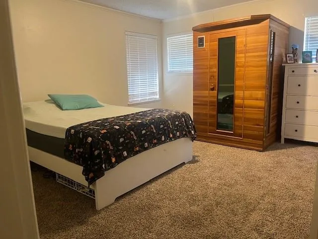 a bed sitting in a bedroom next to a window