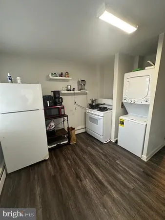 a kitchen with a refrigerator and a stove top oven