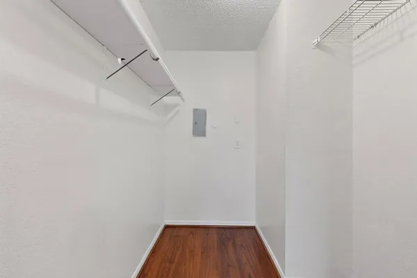 a view of a room with wooden floor