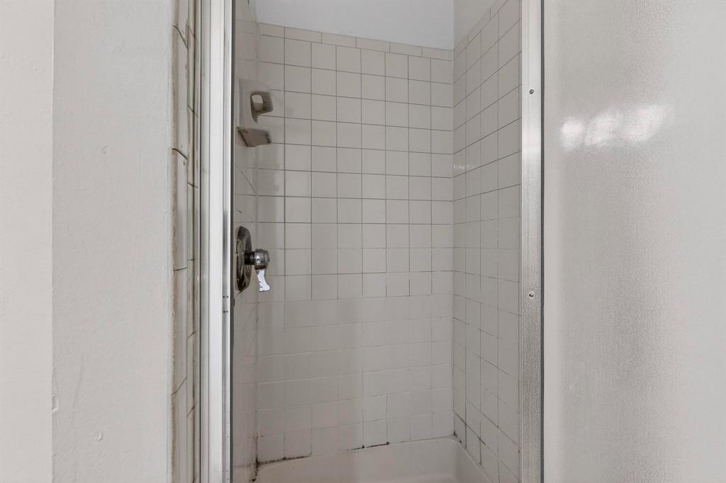8545 Midpark Road, Unit 16 Dallas, TX 75240 - Photo 19 of 29 a bathroom with a glass shower door