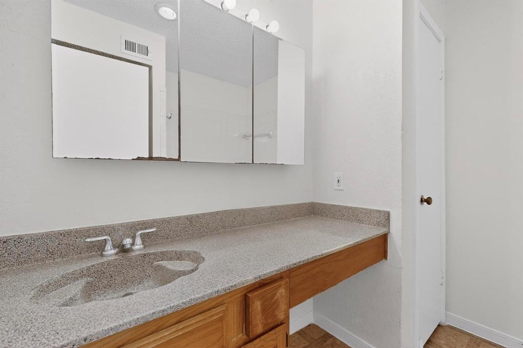 8545 Midpark Road, Unit 16 Dallas, TX 75240 - Photo 23 of 29 a room with granite countertop white cabinets and a sink