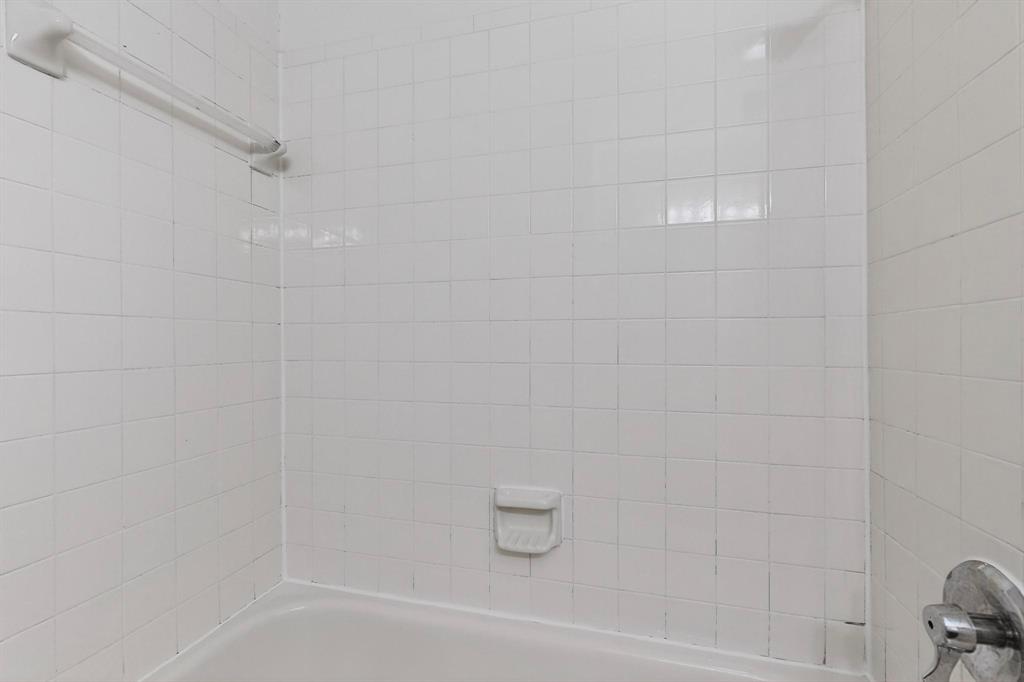 8545 Midpark Road, Unit 16 Dallas, TX 75240 - Photo 25 of 29 a bathroom with a shower