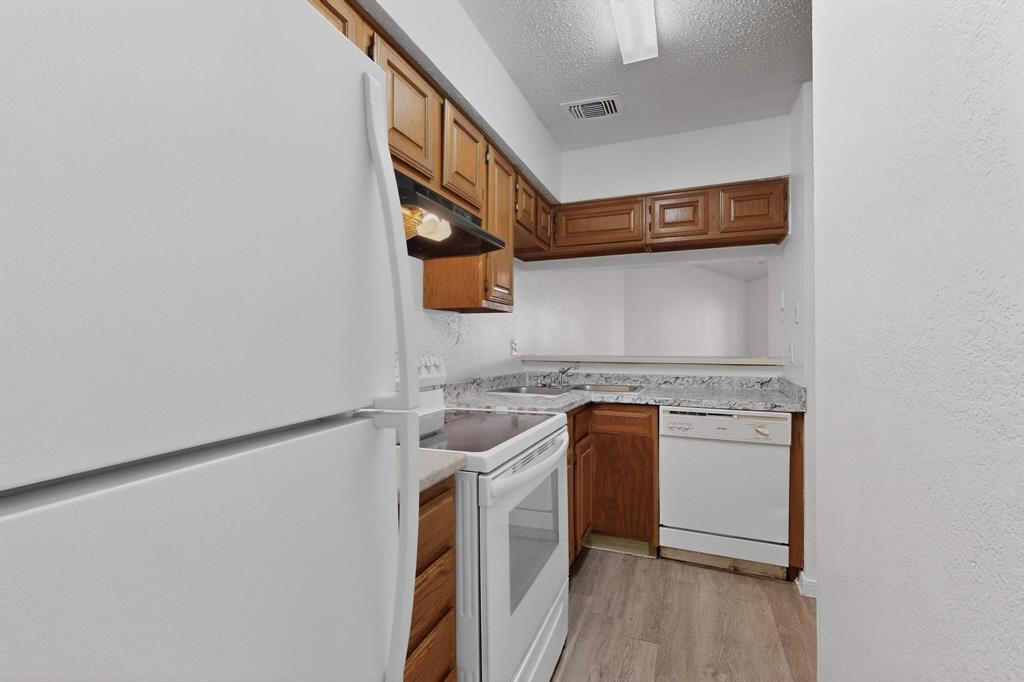 8545 Midpark Road, Unit 16 Dallas, TX 75240 - Photo 6 of 29 a utility room with a sink a washer and dryer