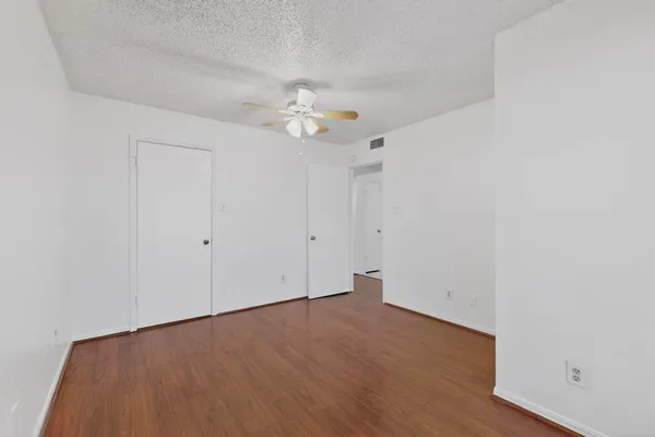 a view of an empty room with a fan