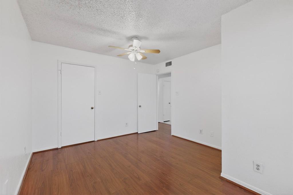 8545 Midpark Road, Unit 16 Dallas, TX 75240 - Photo 9 of 29 a view of an empty room with a fan