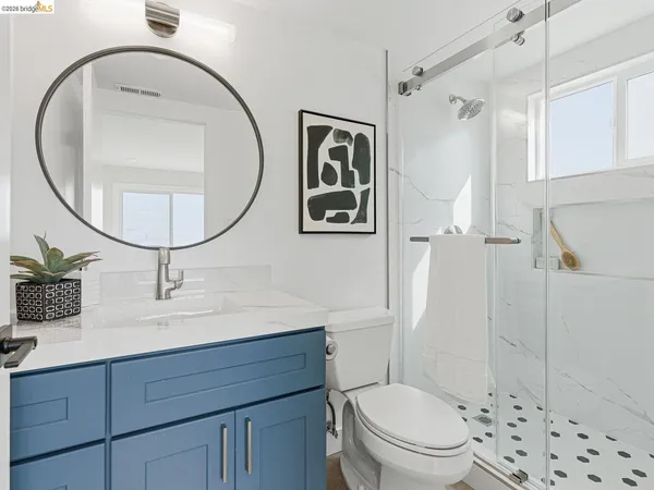 a living room with furniture a window and a potted plant