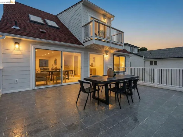 a view of a dinning table and chairs in patio of the house