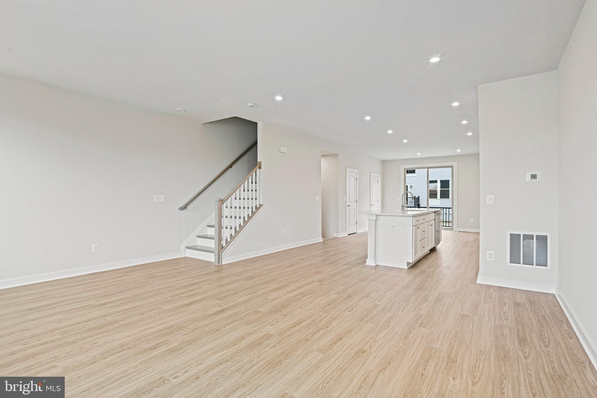 2172 Glacier Road Herndon, VA 20170 - Photo 11 of 33 a view of empty room with wooden floor and kitchen