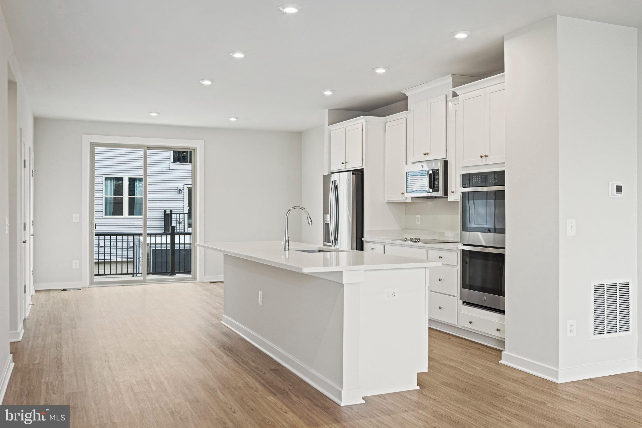 2172 Glacier Road Herndon, VA 20170 - Photo 12 of 33 a kitchen with stainless steel appliances kitchen island granite countertop a stove and a refrigerator