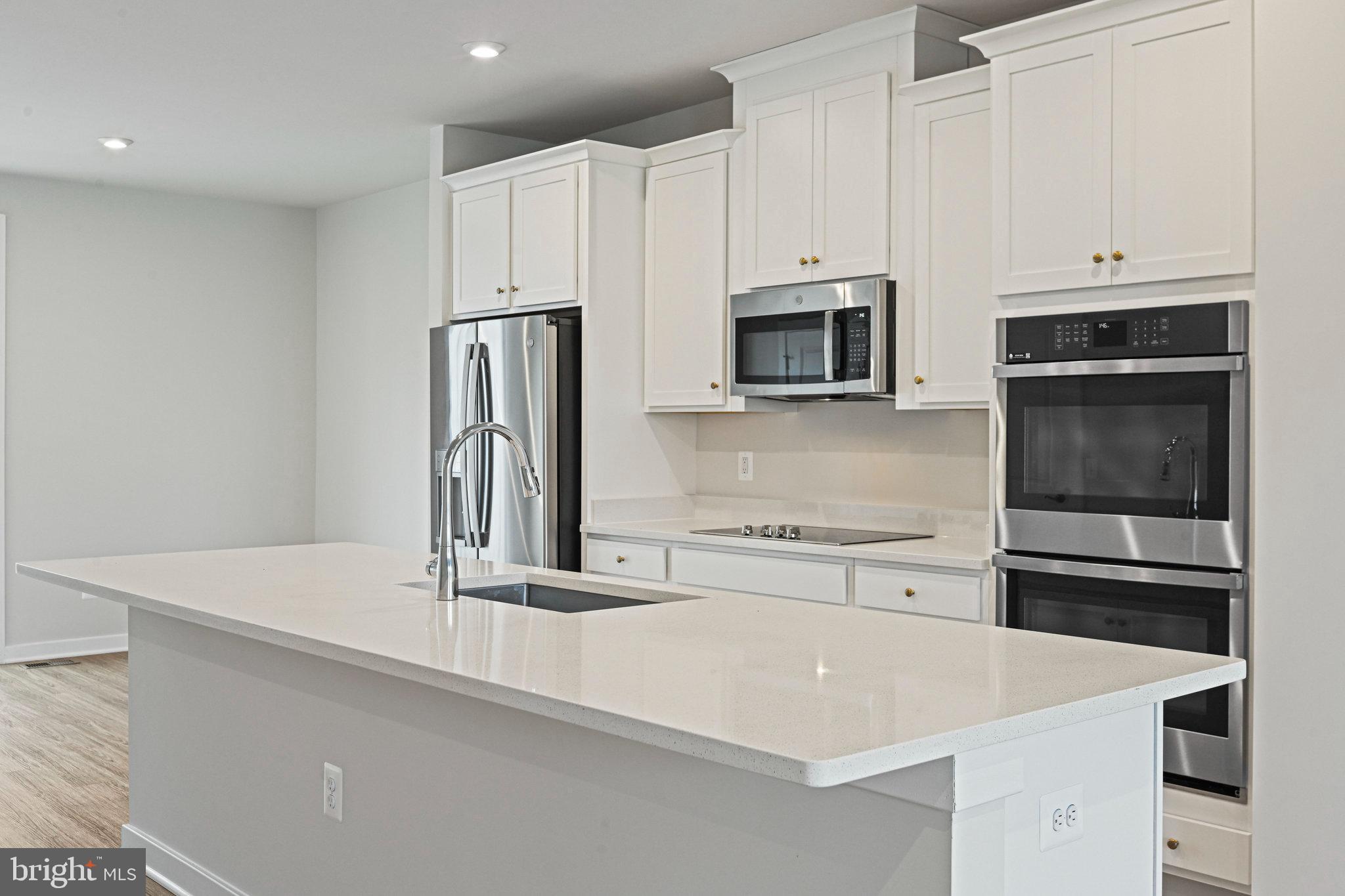 2172 Glacier Road Herndon, VA 20170 - Photo 13 of 33 a kitchen with stainless steel appliances a stove microwave and sink