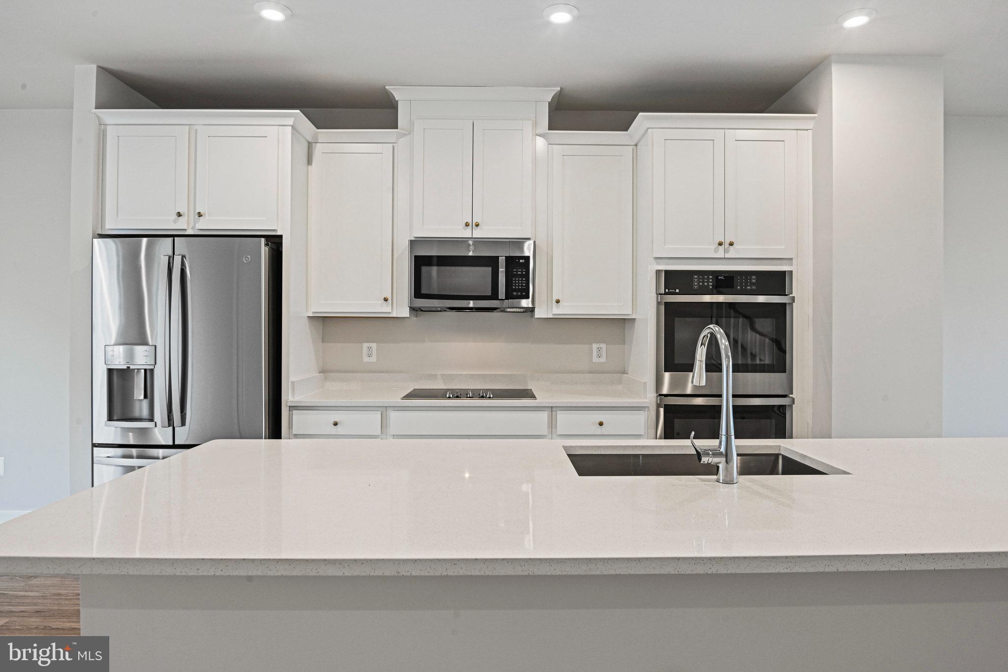 2172 Glacier Road Herndon, VA 20170 - Photo 14 of 33 a kitchen with kitchen island a white counter top space and cabinets
