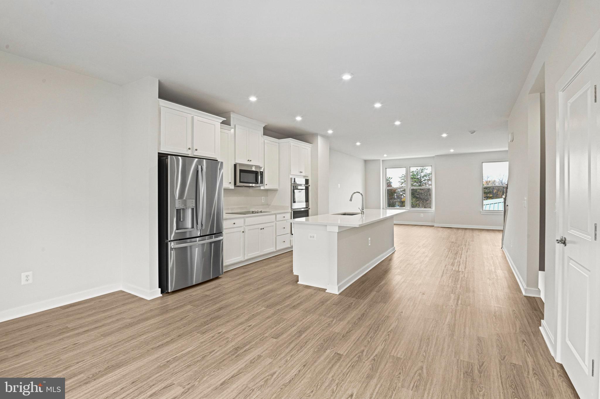2172 Glacier Road Herndon, VA 20170 - Photo 15 of 33 a kitchen with stainless steel appliances a refrigerator and wooden floor