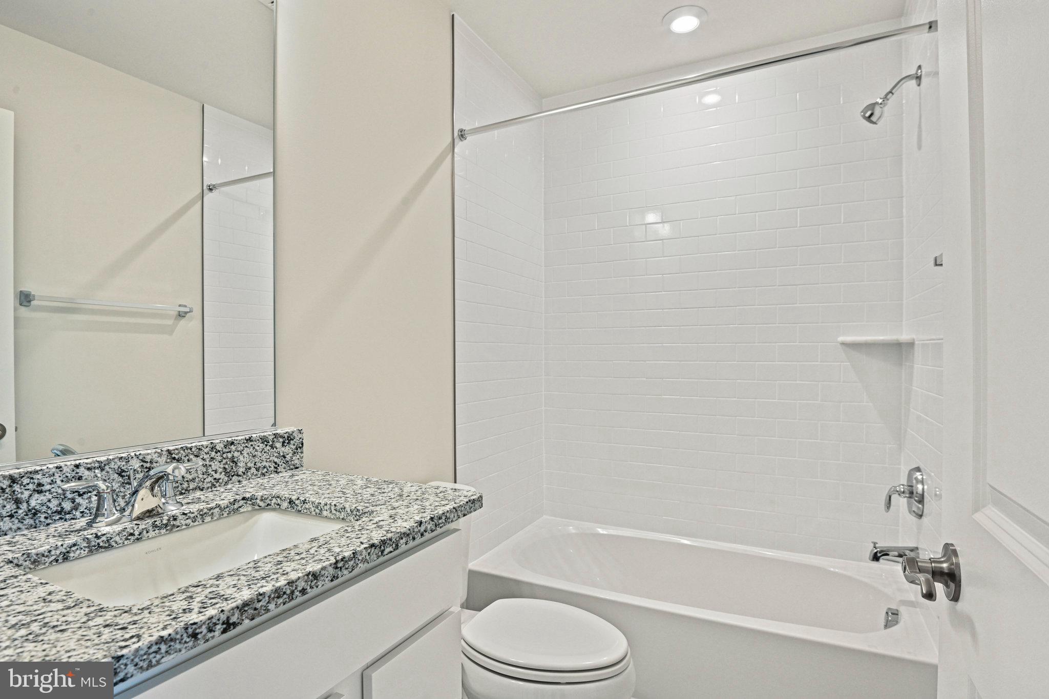 2172 Glacier Road Herndon, VA 20170 - Photo 25 of 33 a bathroom with a granite countertop sink toilet and shower