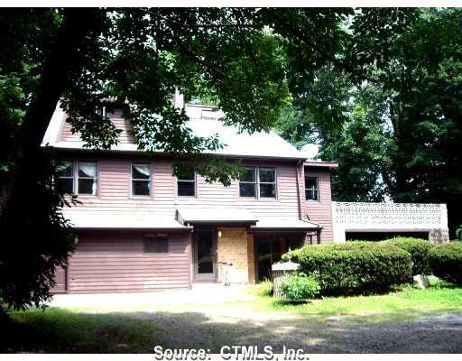 Exterior Front. 3 -STORIES CONT CAPE WITH STONE PATIO OVER LOOKING LANDSCAPED YARD