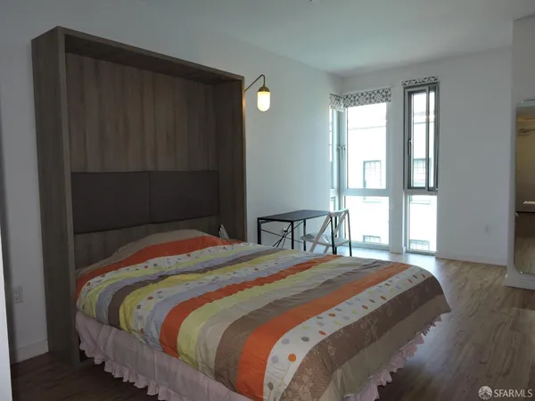 a room with a bed and a television