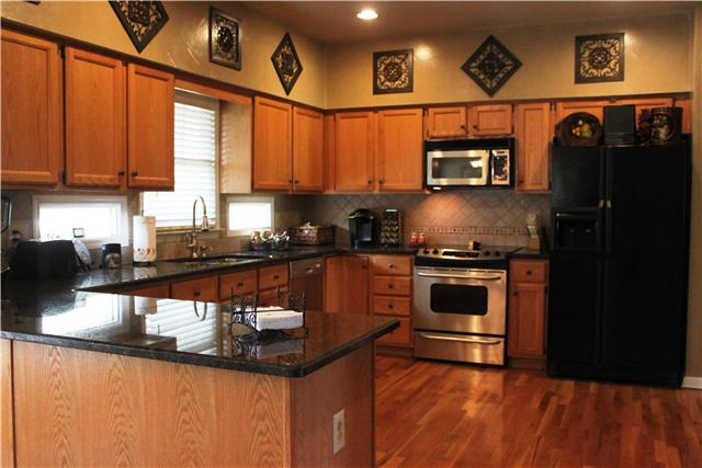 437 Ridgestone Drive Franklin, TN 37064 - Photo 5 of 20 Open kitchen w/granite, tile backsplash, hardwoods, SS appl & large pantry.