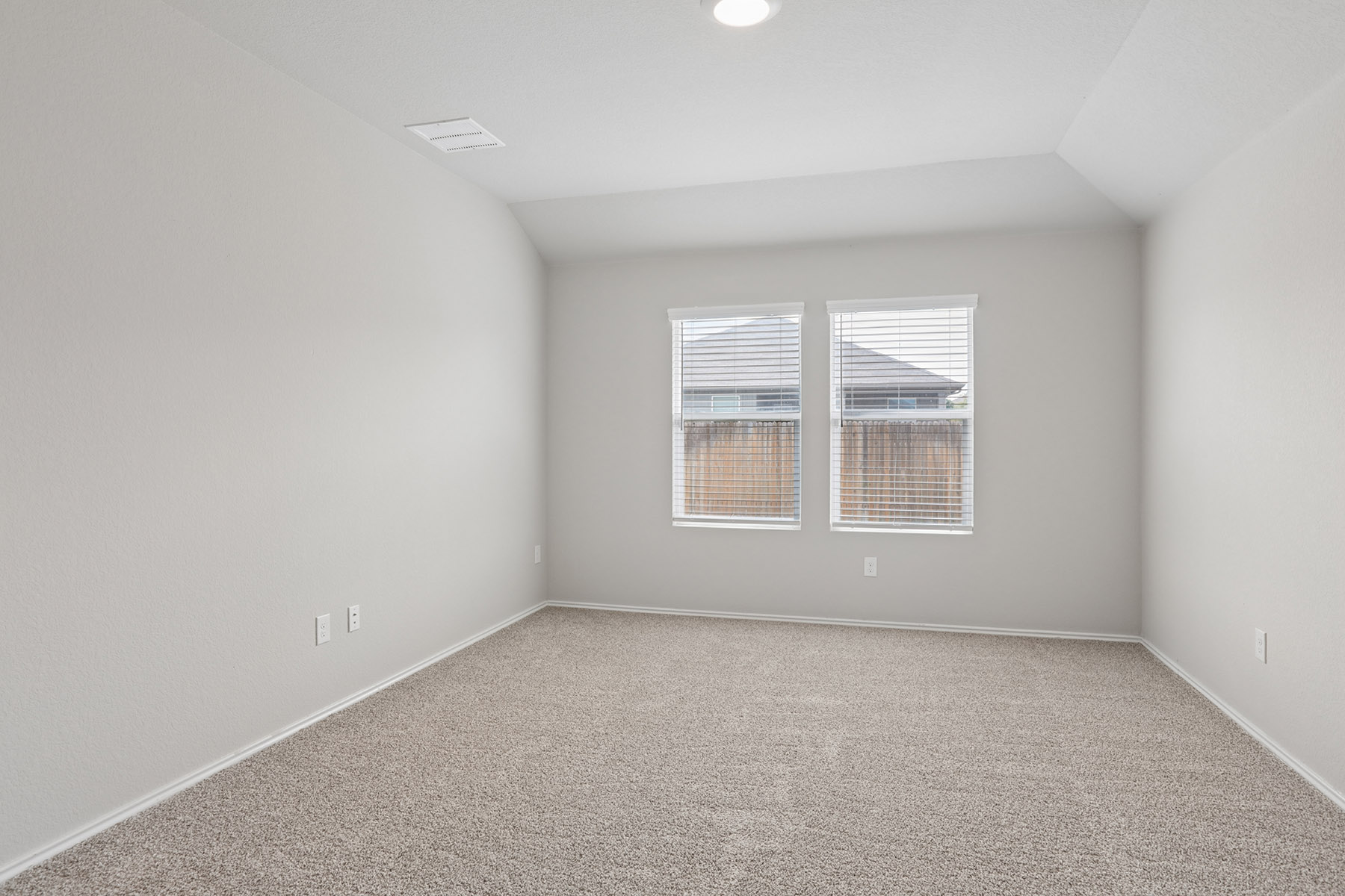 15217 Upland Willow Road Austin, TX 78724 - Photo 19 of 25 Master bedroom with vaulted ceiling and baseboards