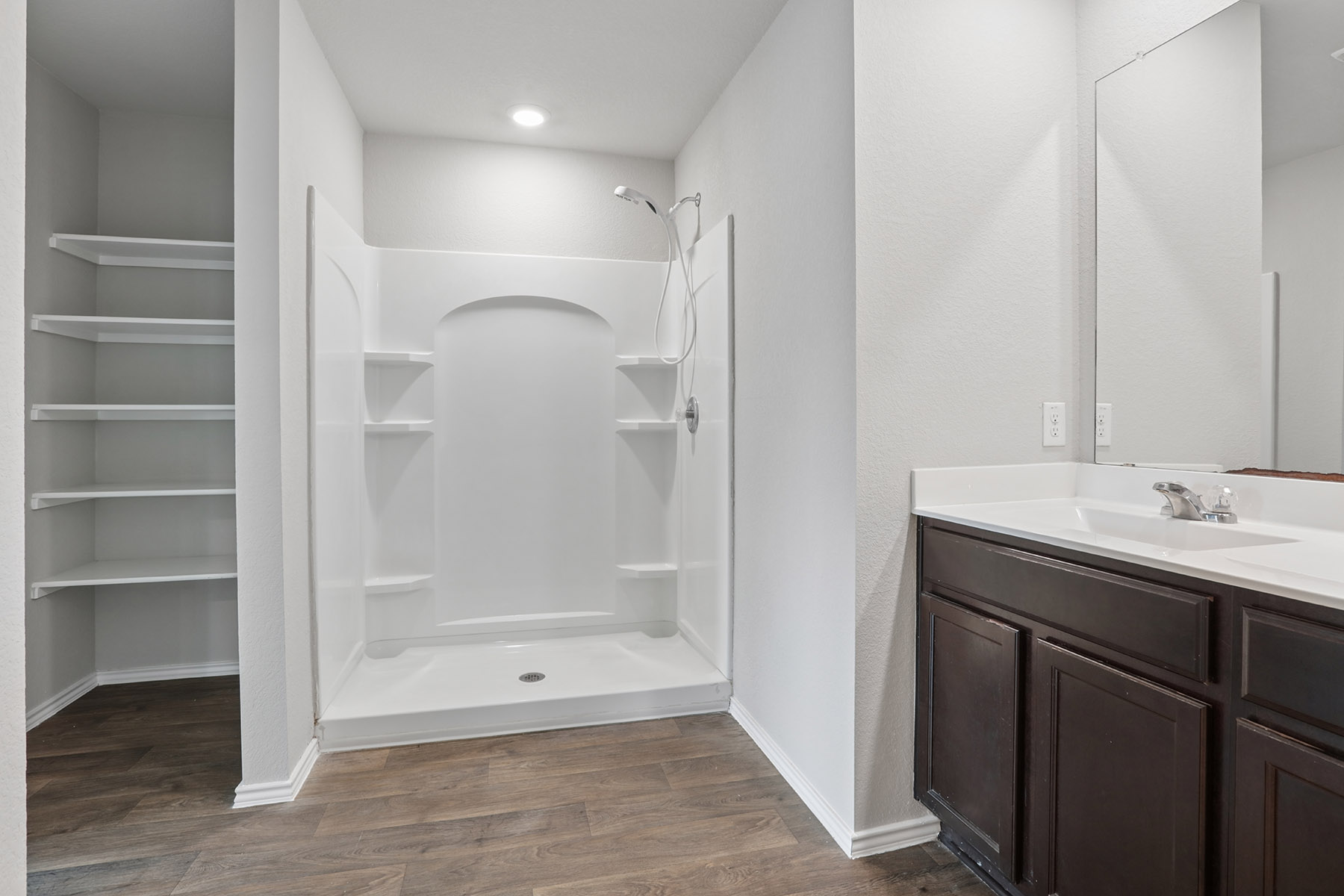 15217 Upland Willow Road Austin, TX 78724 - Photo 20 of 25 Master Bathroom with a shower stall, vanity, and dark wood finished floors