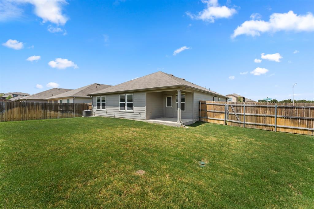 15217 Upland Willow Road Austin, TX 78724 - Photo 23 of 25 Rear view of property featuring a patio area and a fenced backyard