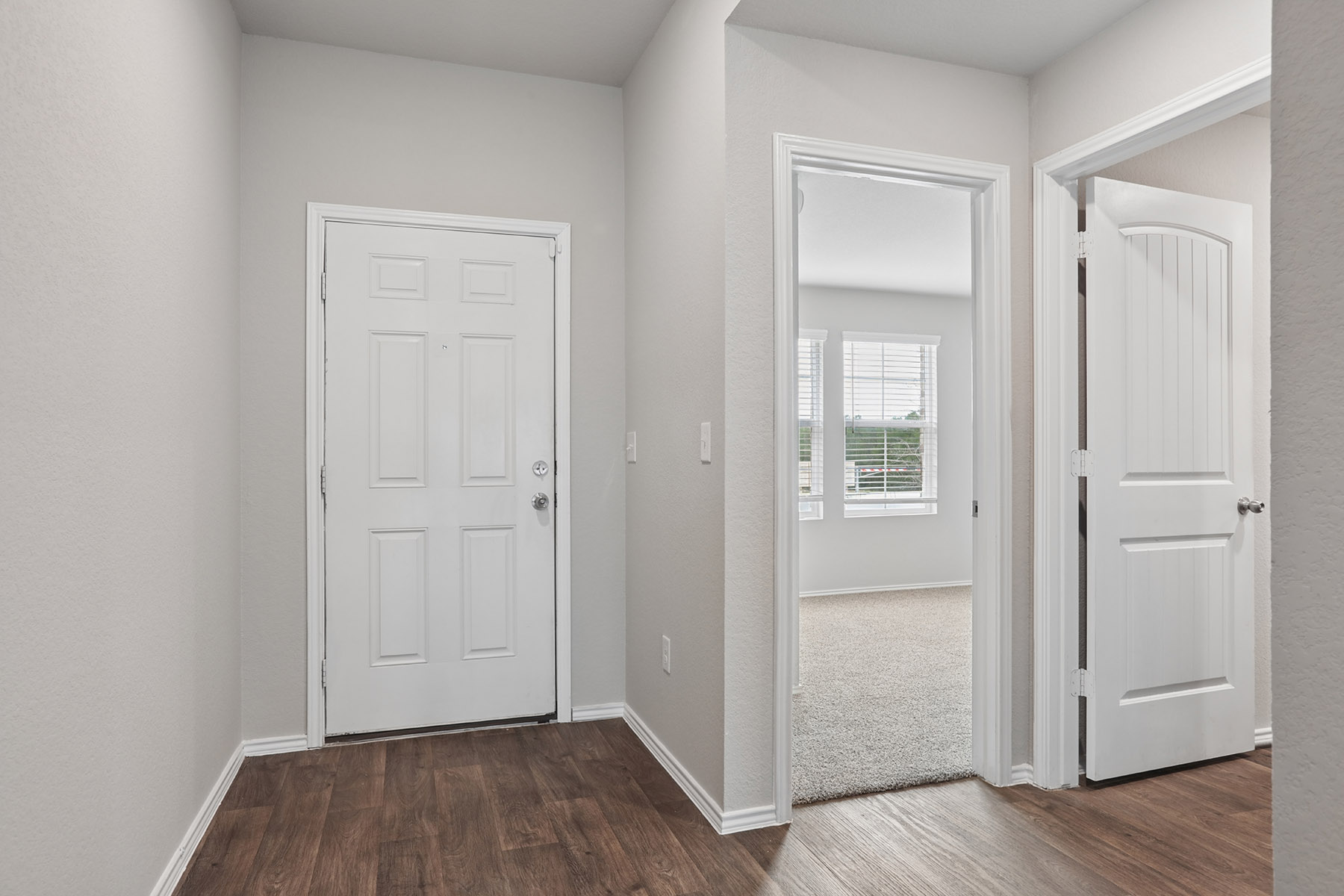 15217 Upland Willow Road Austin, TX 78724 - Photo 5 of 25 Hallway featuring dark wood-style floors and baseboards