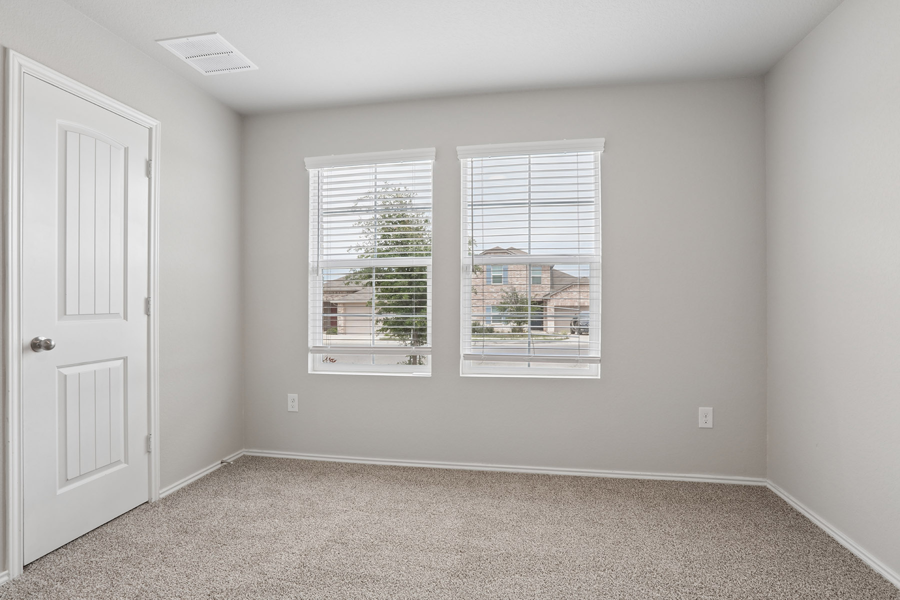 15217 Upland Willow Road Austin, TX 78724 - Photo 8 of 25 Unfurnished bedroom with light colored carpet and baseboards