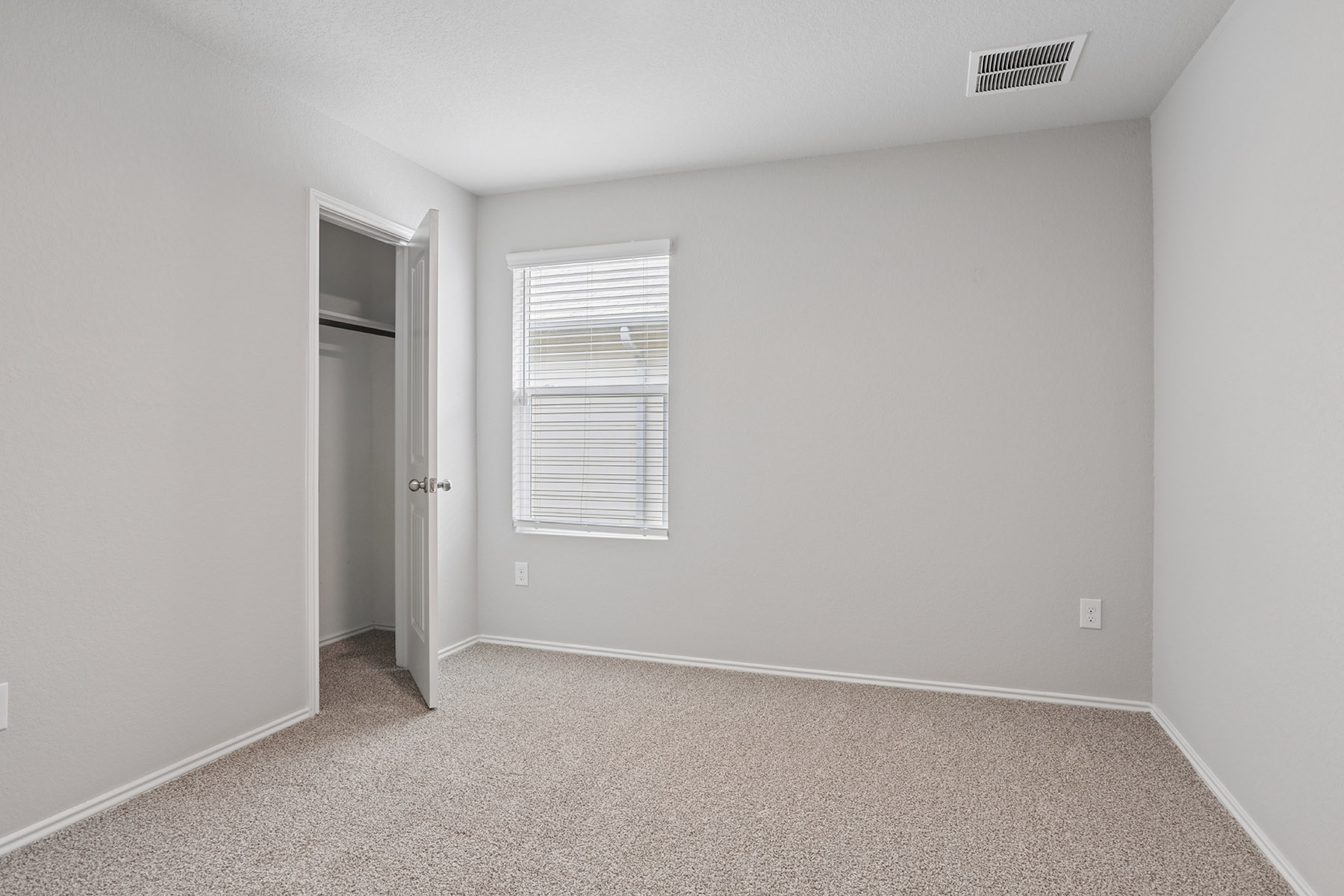 15217 Upland Willow Road Austin, TX 78724 - Photo 10 of 25 Unfurnished bedroom with light carpet and a closet