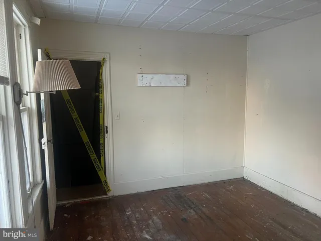 an empty room with wooden floor