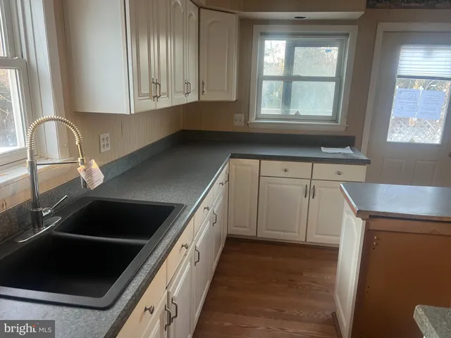 a kitchen with granite countertop a sink and a stove