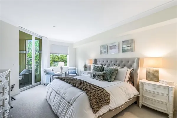 a bedroom with a bed and large window