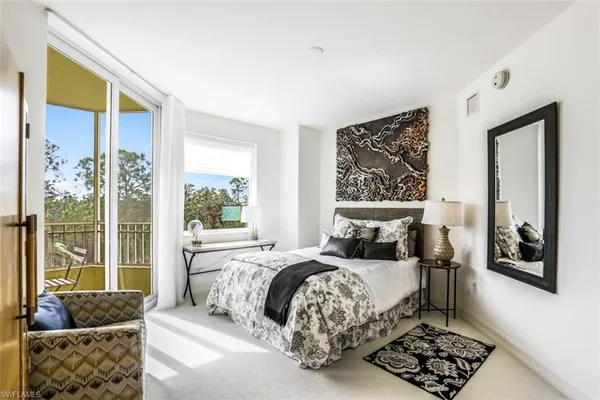 a bedroom with a large bed and a couch