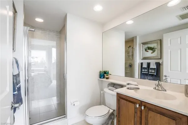a bathroom with a sink toilet a mirror and shower