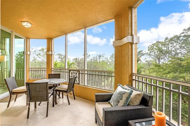 a living room with furniture and floor to ceiling windows