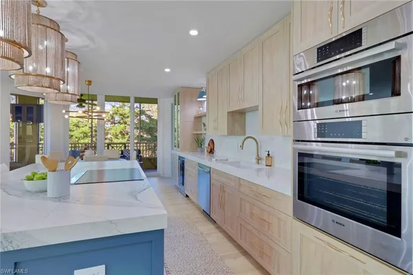 a kitchen with stainless steel appliances a stove microwave and cabinets