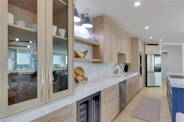 a kitchen with a refrigerator and a sink