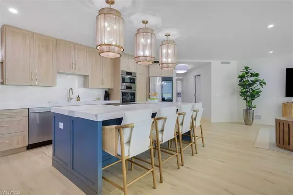 a kitchen with cabinets dining table and chairs