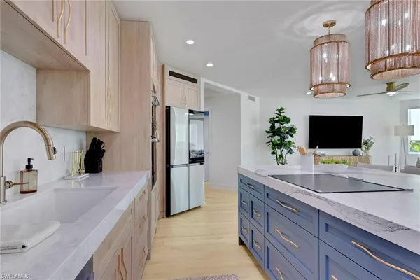 a kitchen with stainless steel appliances a sink microwave and refrigerator