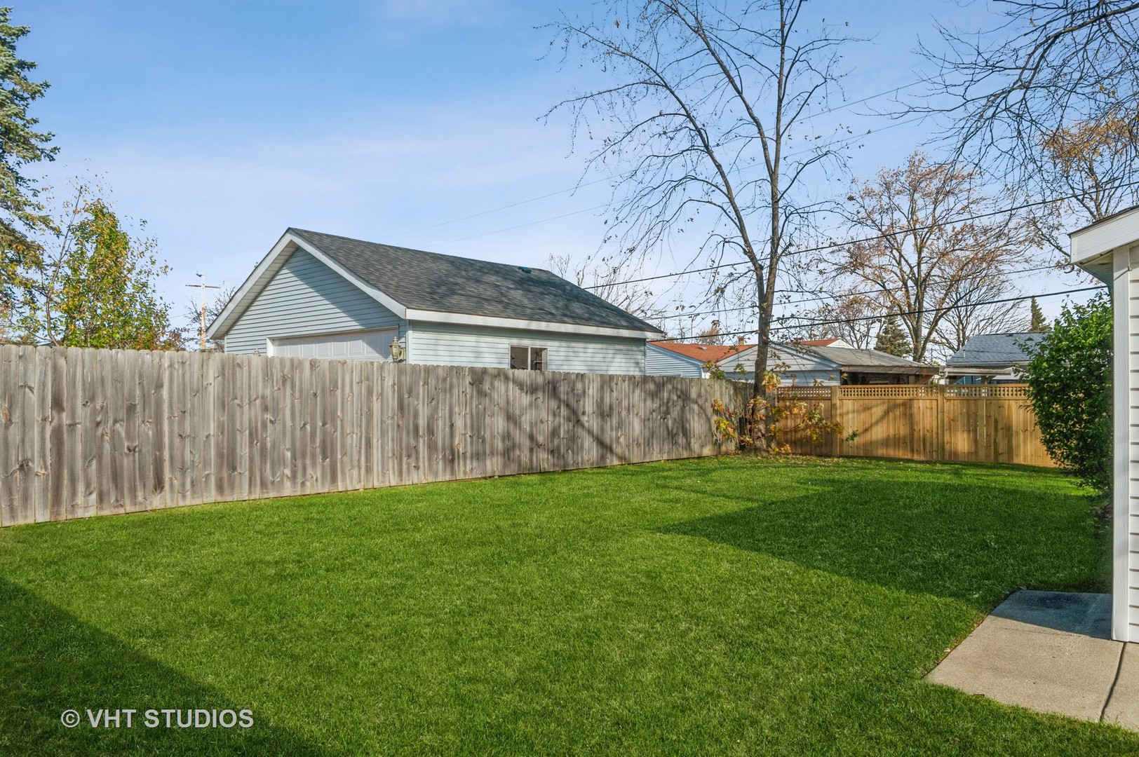 155 East Dennis Road Wheeling, IL 60090 - Photo 2 of 10 a backyard of a house with plants and large tree