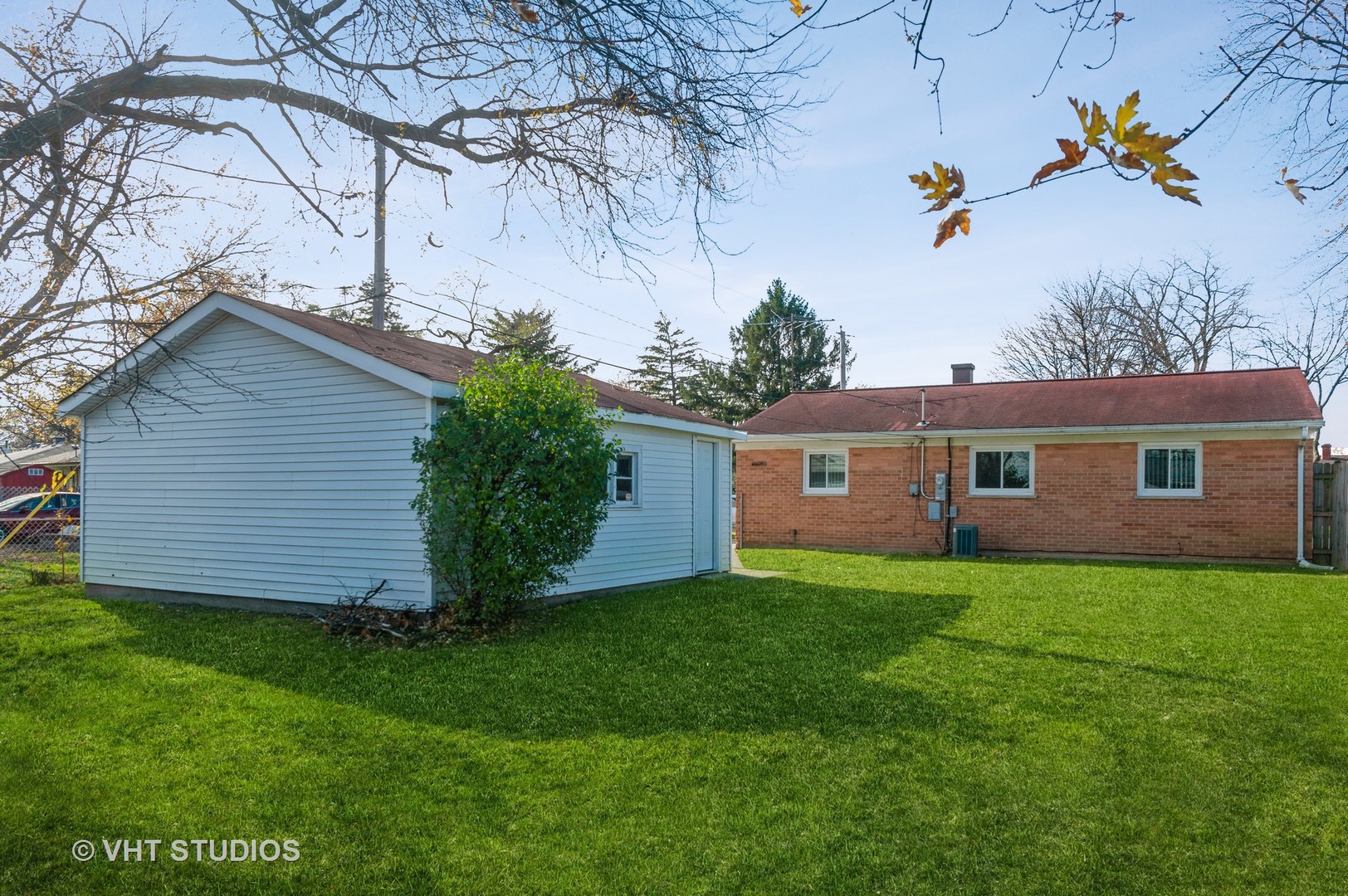 155 East Dennis Road Wheeling, IL 60090 - Photo 3 of 10 a view of a yard in front of a house with plants and large tree