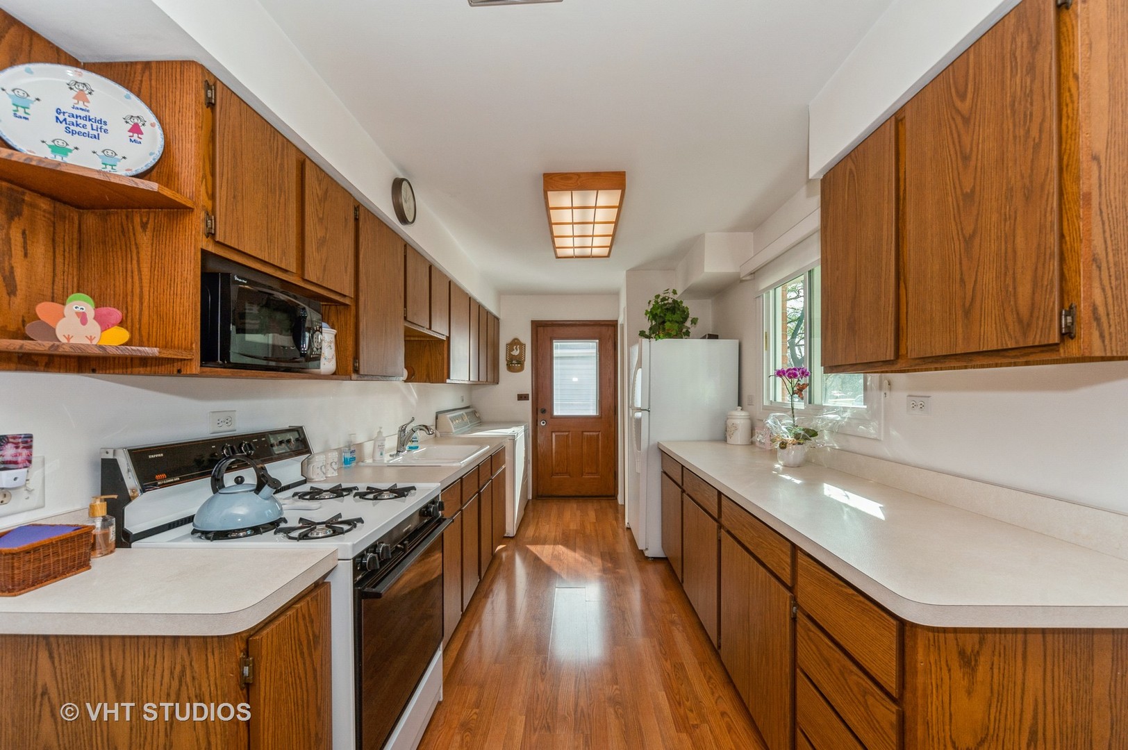 155 East Dennis Road Wheeling, IL 60090 - Photo 5 of 10 a kitchen with stainless steel appliances granite countertop a sink stove and cabinets