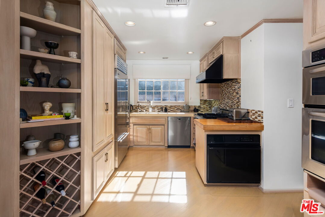 4247 Sespe Avenue Sherman Oaks, CA 91403 - Photo 12 of 31 a kitchen with stainless steel appliances granite countertop a stove a sink and a refrigerator