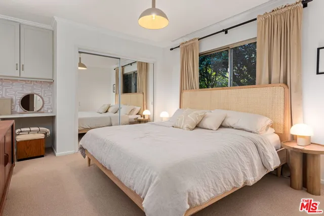 a bedroom with a bed a fireplace and a window